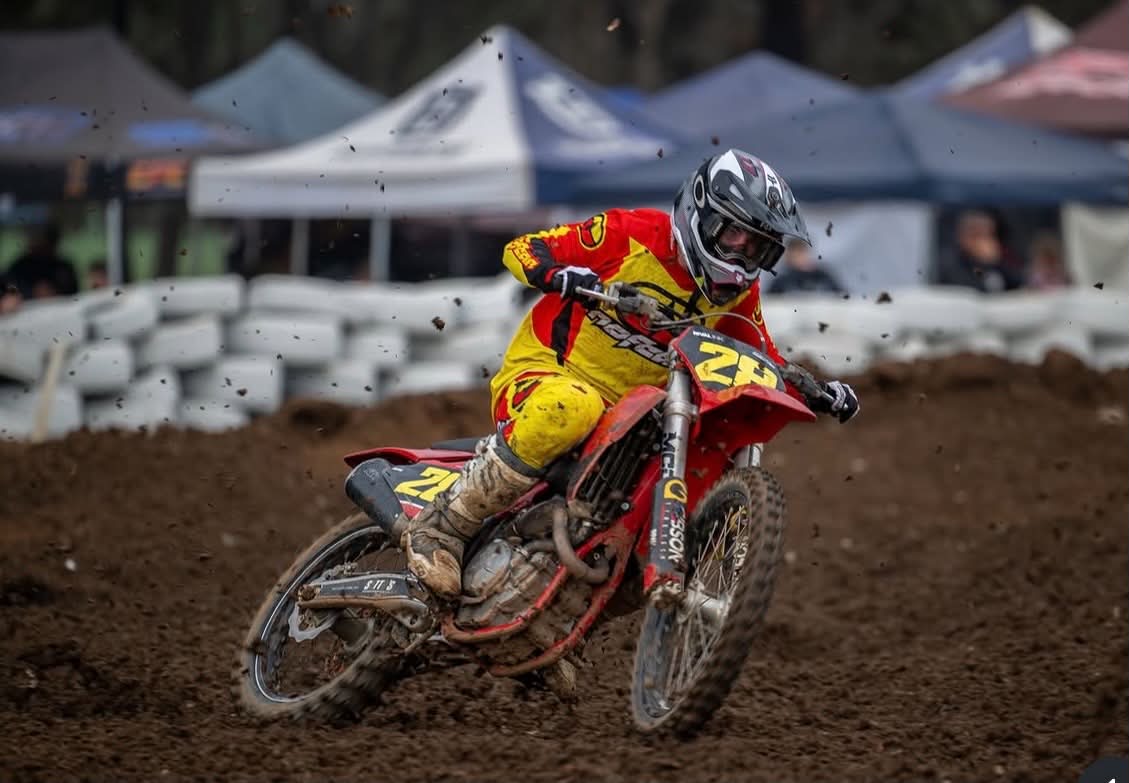Rafael Rossiter cornering on his motocross bike in No Fear racing gear